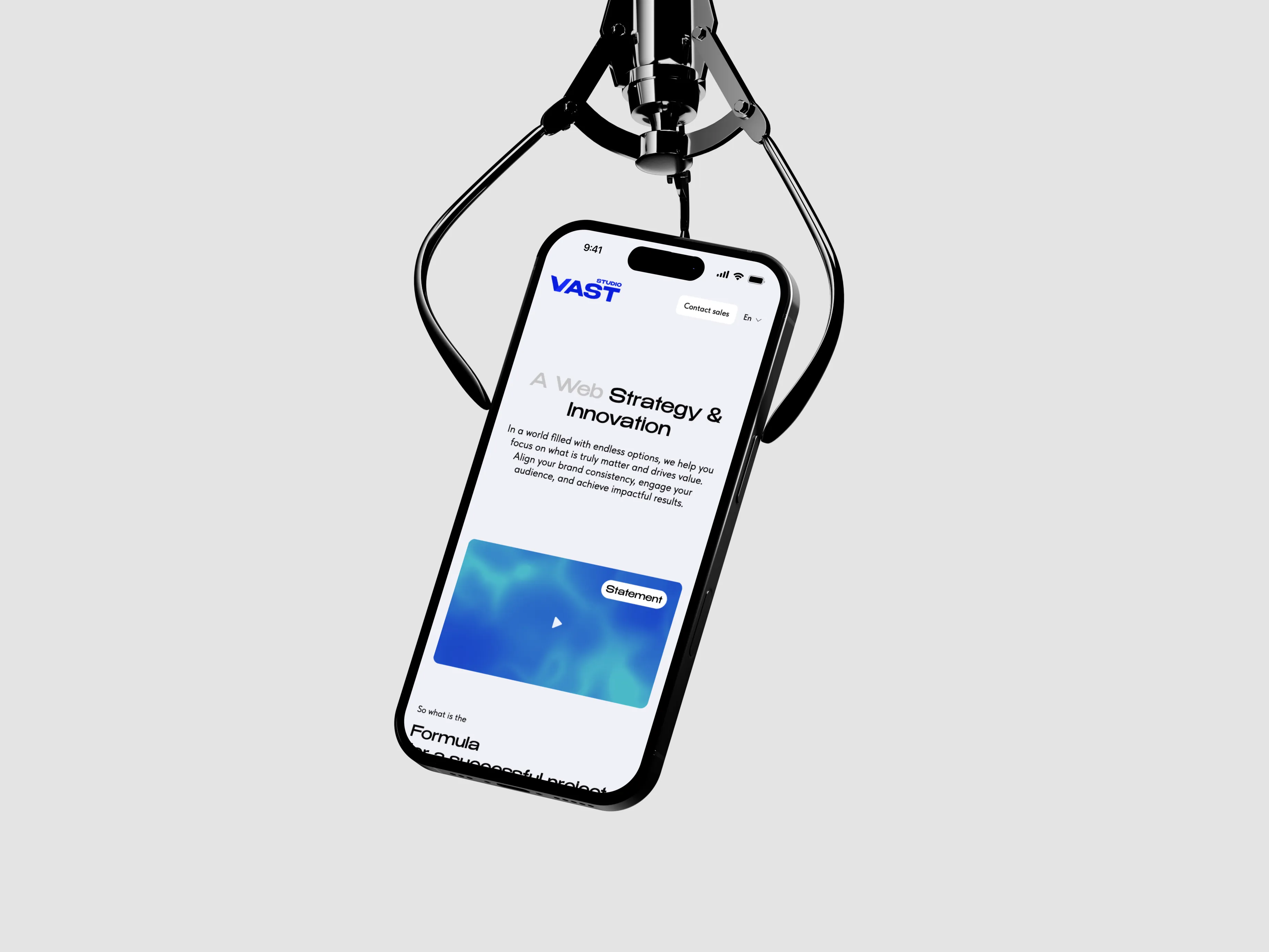 Black claw crane holding a smartphone displaying a website about web strategy and innovation.