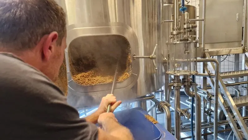 Hard work and intense heat during the brewing process. The brew master is used to the heat because of the offshore works he has been doing all over the world.