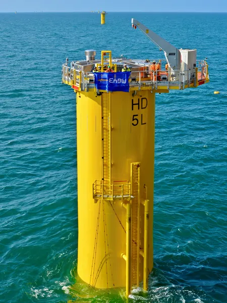 Offshore wind foundations at He Dreiht showing large steel monopiles installed in the seabed with transition pieces mounted on top, manufactured by Steelwind Nordenham and the Sif Smulders joint venture, positioned at sea for future turbine installation.