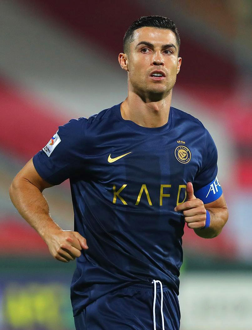 Soccer player Cristiano Ronaldo in navy blue Al Nassr jersey with captain's armband during a match.