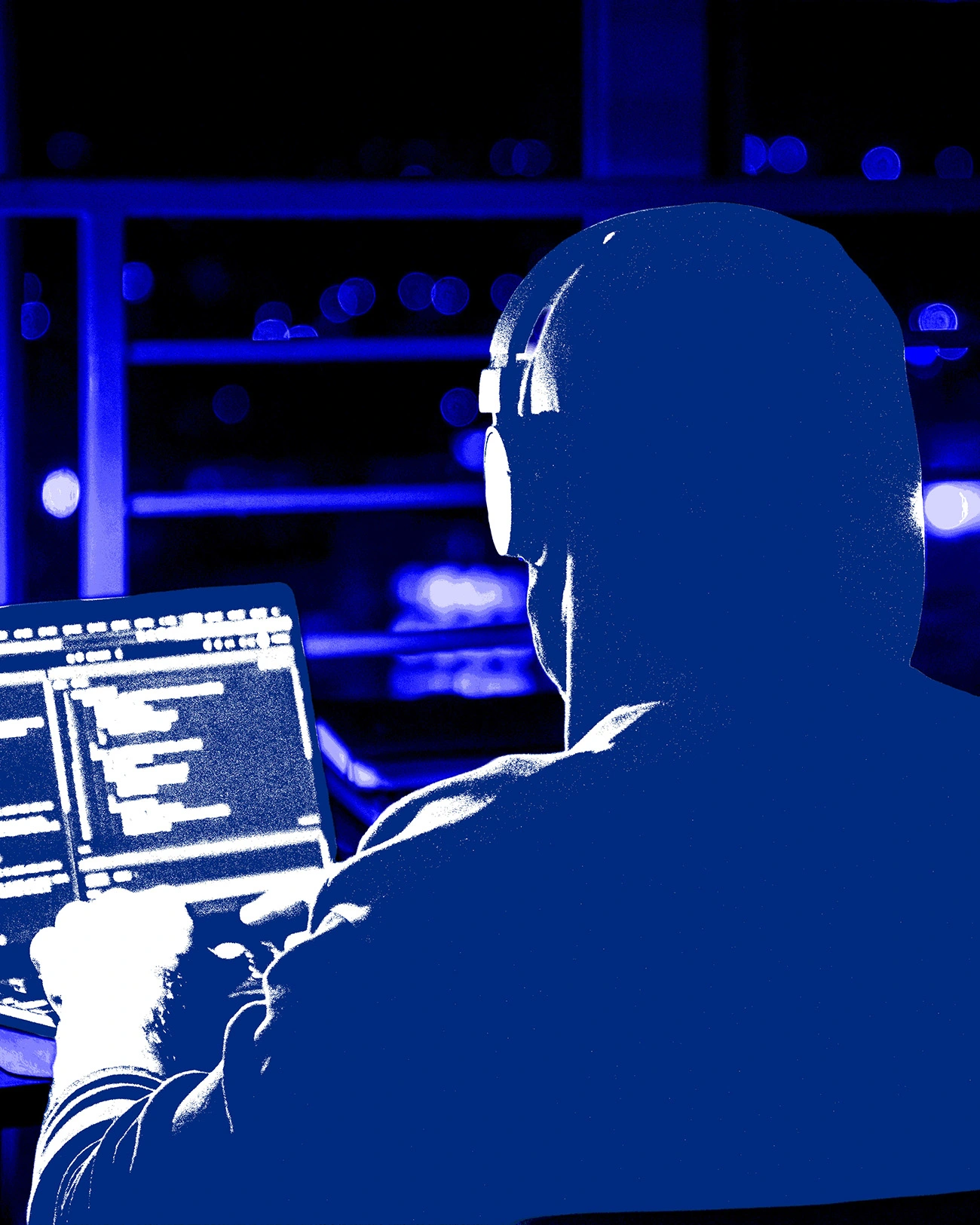 Person working on laptop with code on screen.