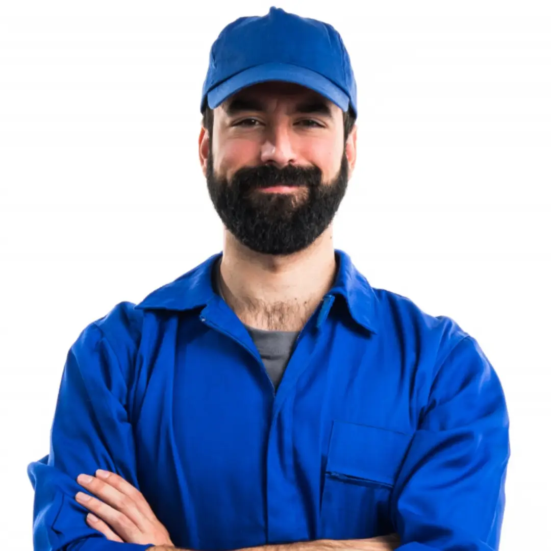 Smiling man with beard wearing a blue cap and blue work uniform with arms crossed.