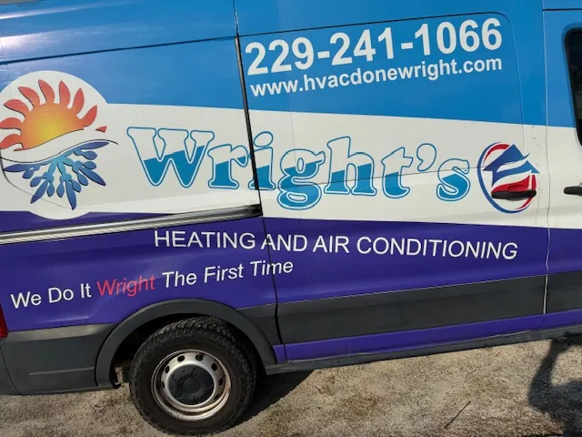 Side of a blue and white van displaying Wright's Heating and Air Conditioning with phone number 229-241-1066 and website www.hvacdonewright.com.