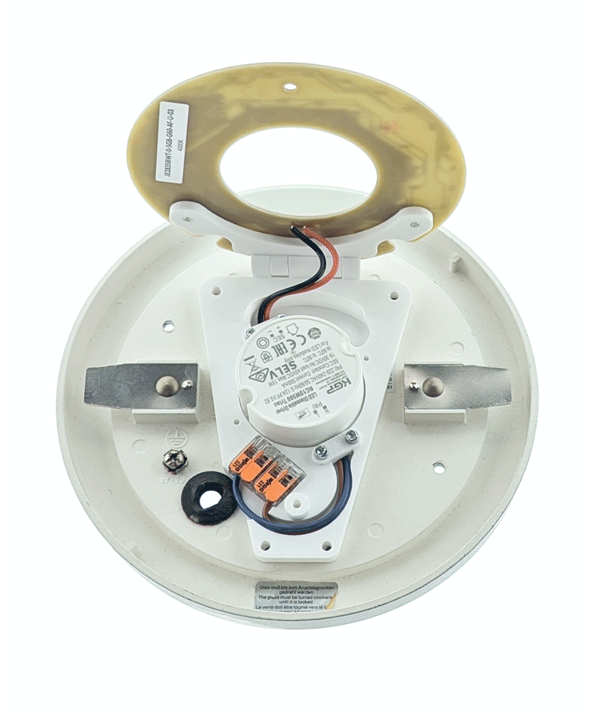 Geöffnete LED-Umrüsteinheit mit sichtbarer Elektronik und Anschlussklemmen auf rundem weißen Gehäuse.