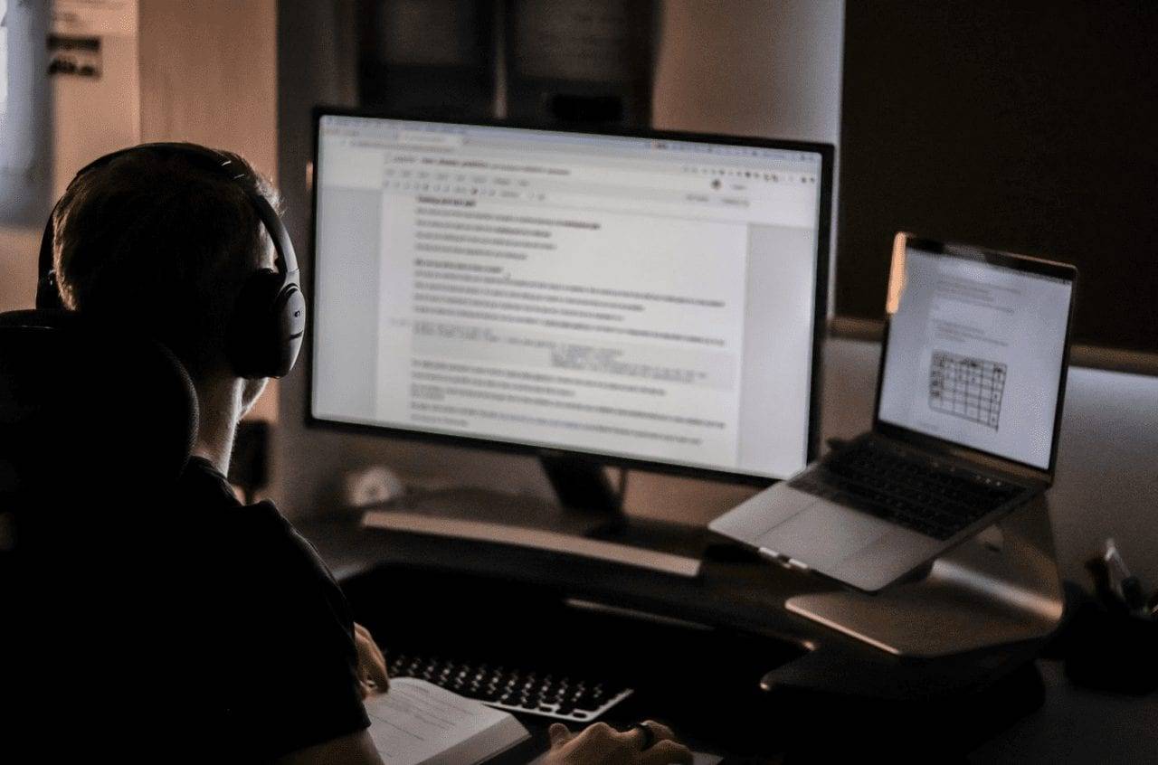 Coworking member working late at a desk, illustrating 24/7 access and flexible workspace availability.