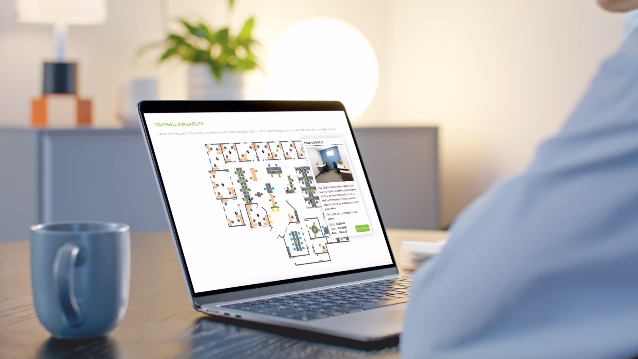 Laptop displaying an interactive coworking floor plan with available private offices.