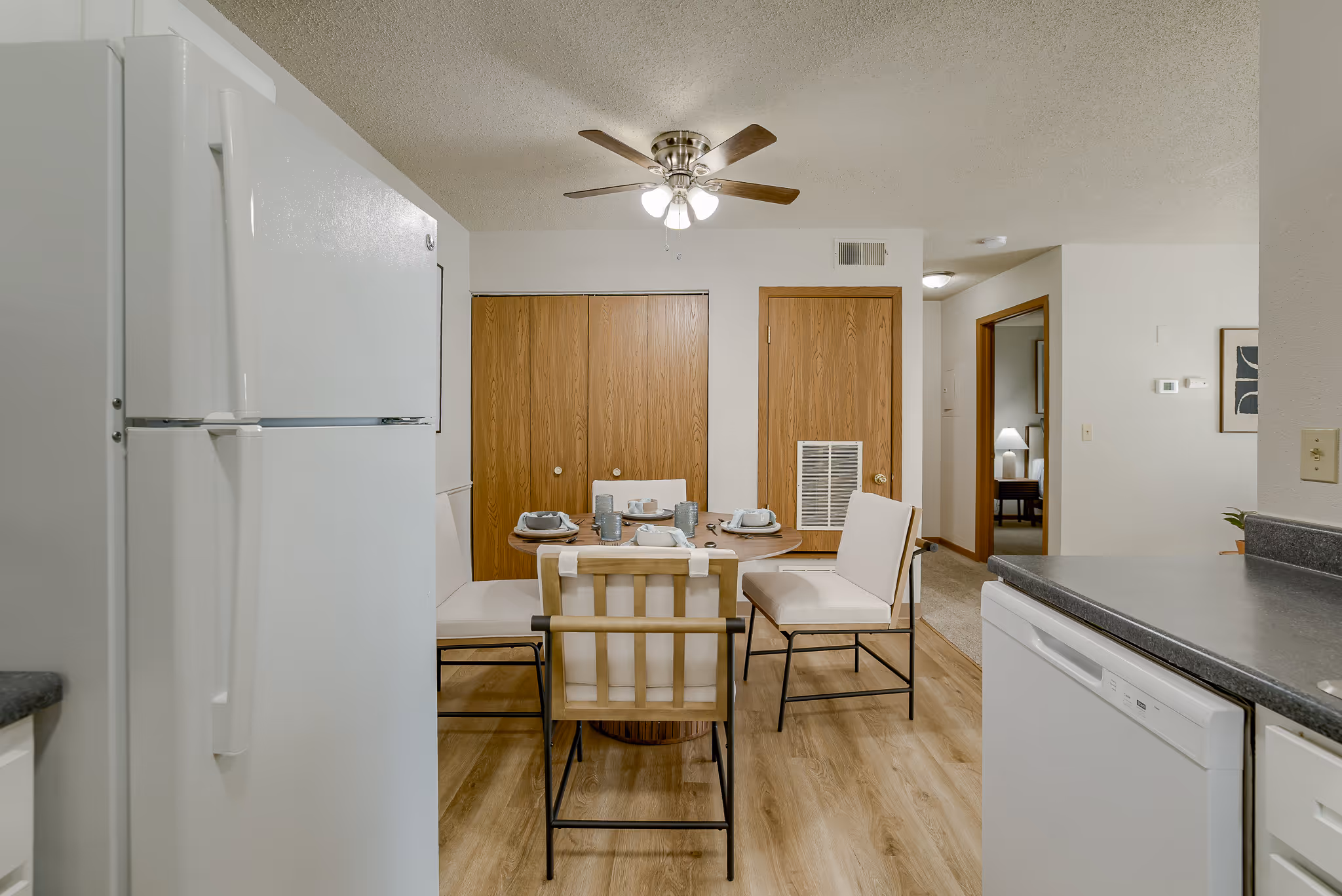 Kitchen area with white cabinets 