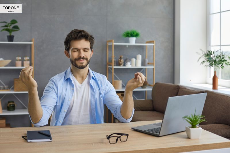 How to become a funded traderâ€”calm trader meditating at desk, symbolizing discipline and mindset needed for successful funded trading