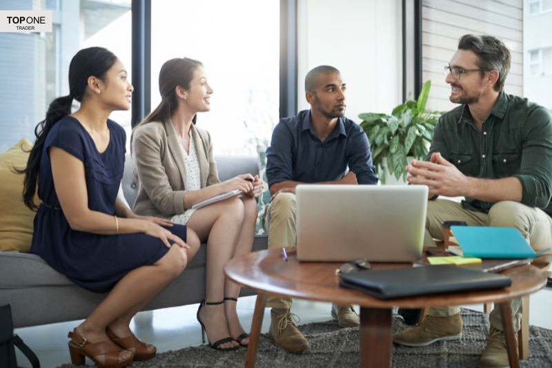 Team discussing profits, highlighting how much do prop firm traders make through collaboration.