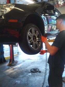 a mechanic balancing a wheel