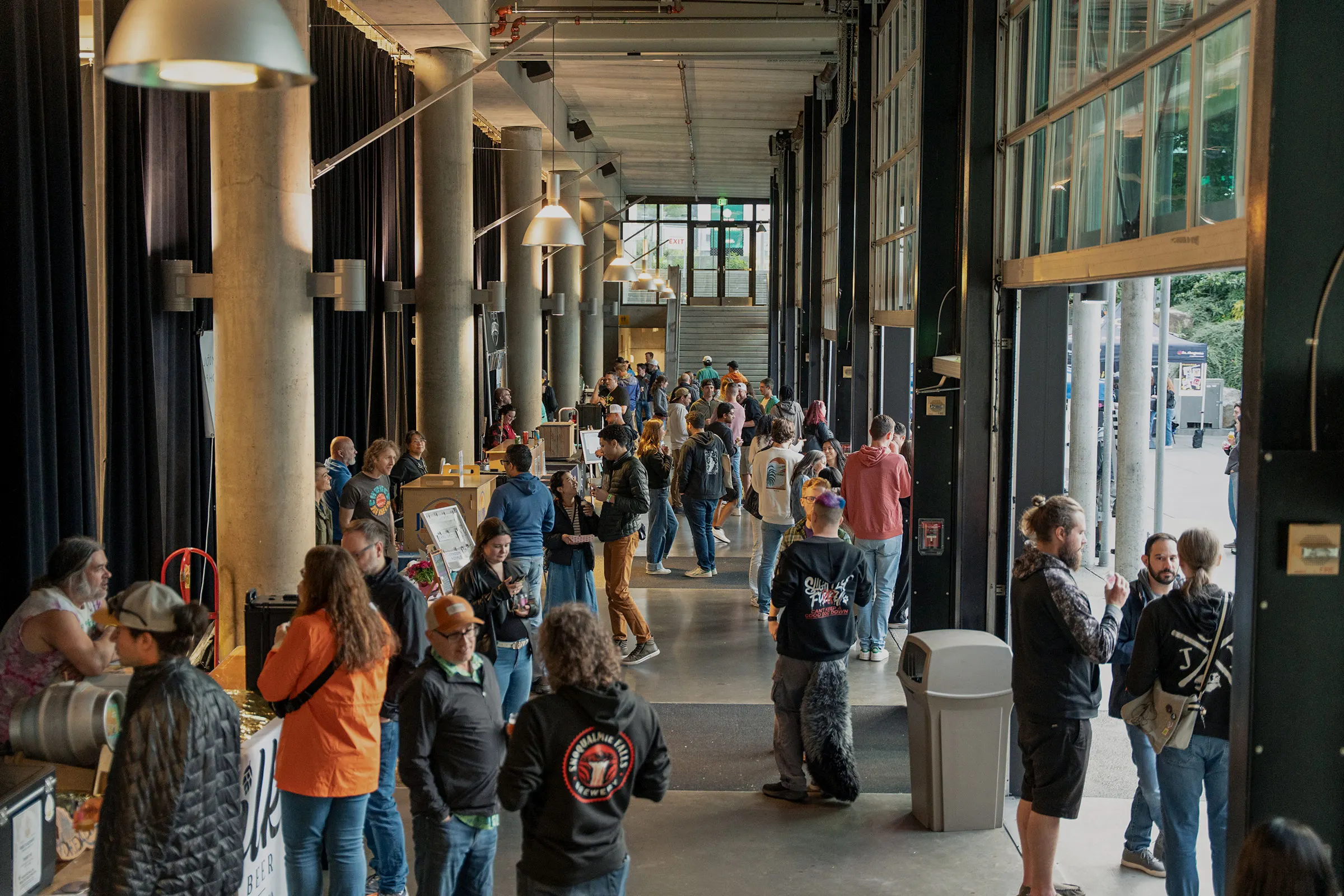 Attendees gathering and networking inside a large event hall during a Washington brewing industry event