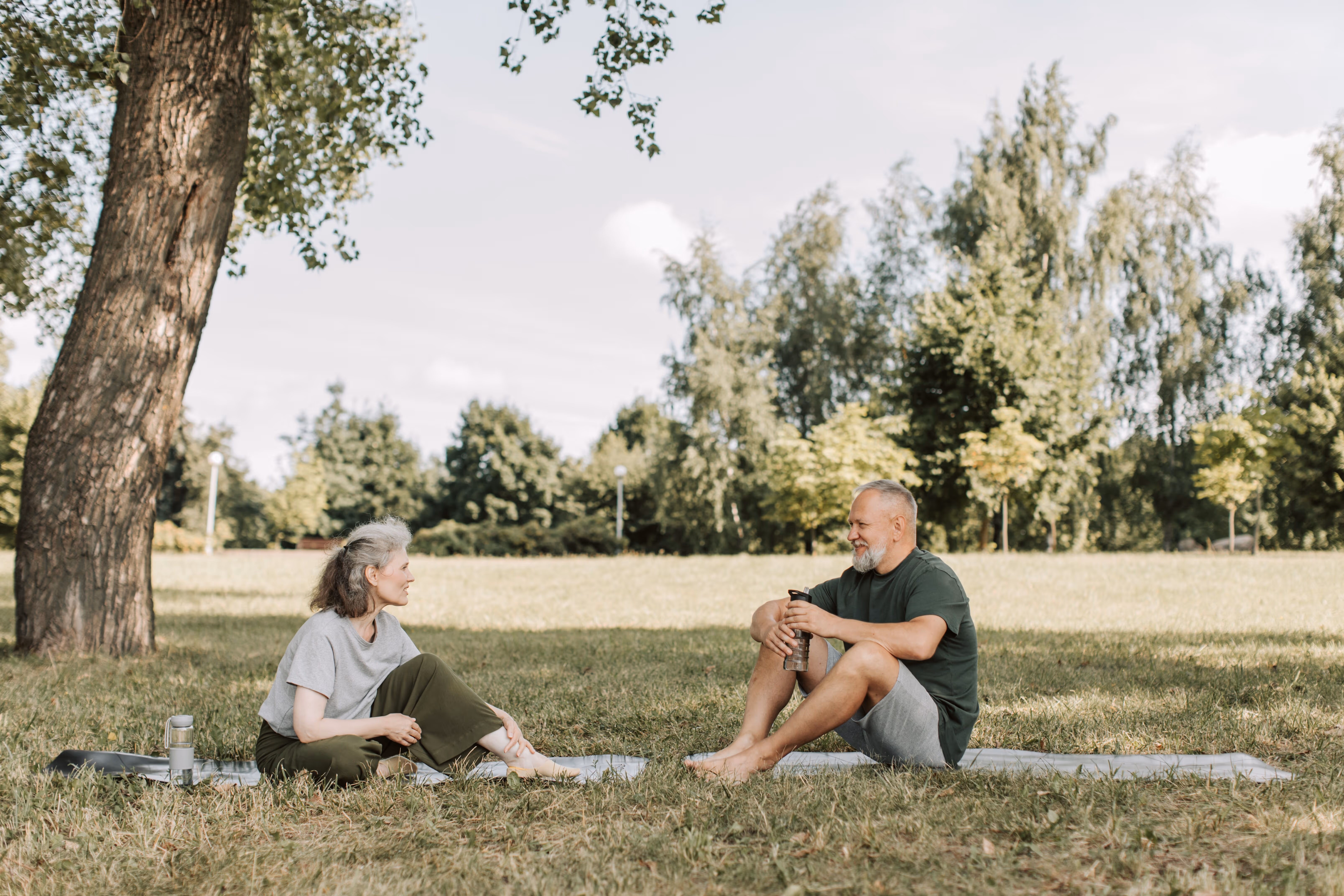 seniors sitting outside in grass stock image