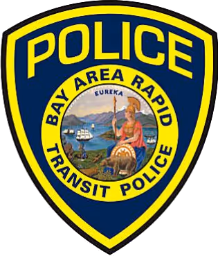 Badge of Bay Area Rapid Transit Police featuring a shield with the word POLICE and a central circular emblem depicting a seated figure with a spear, a ship, and mountains.