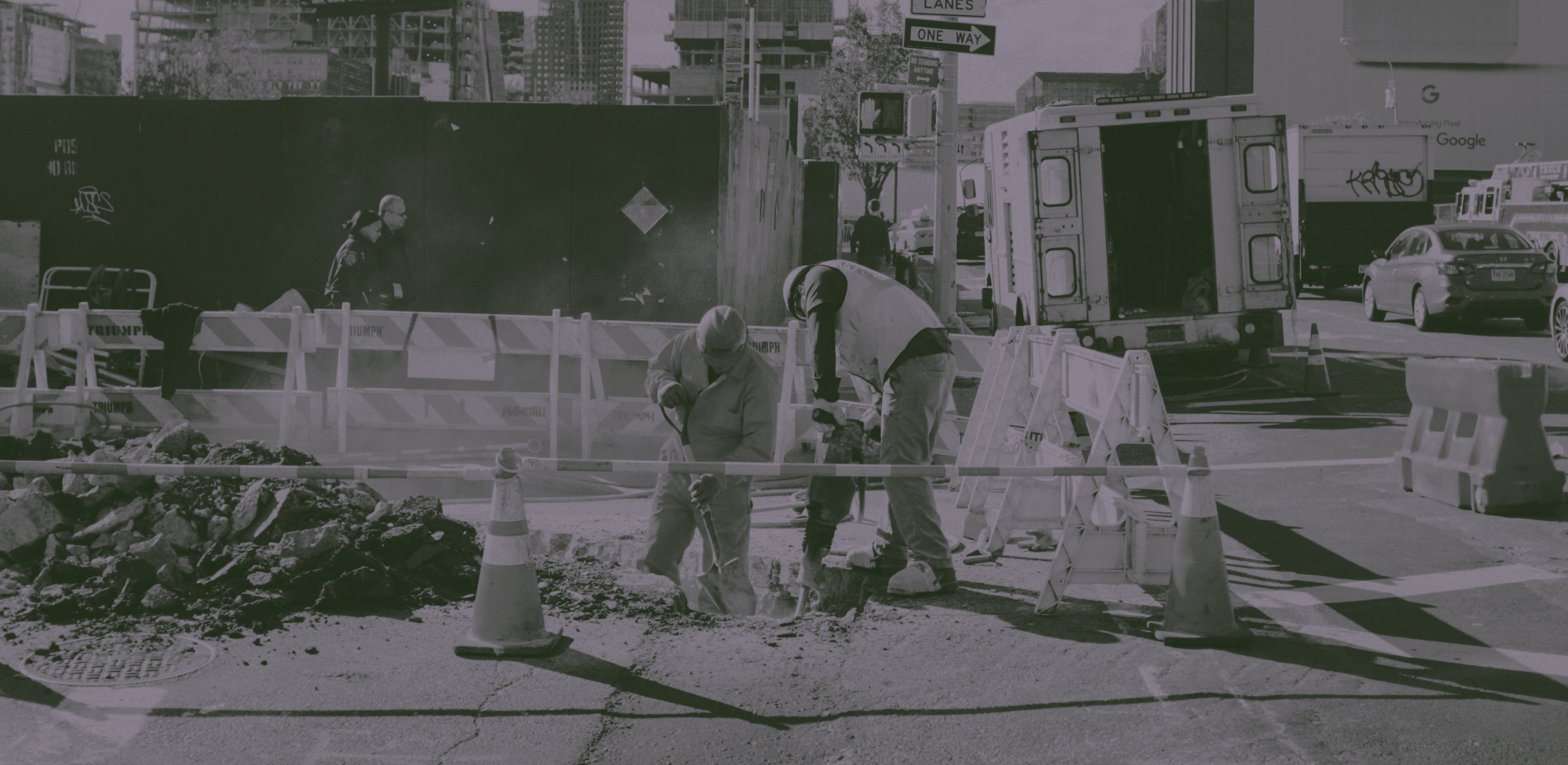 Crew member tapping into a water main protected by a Wraptor safety blanket