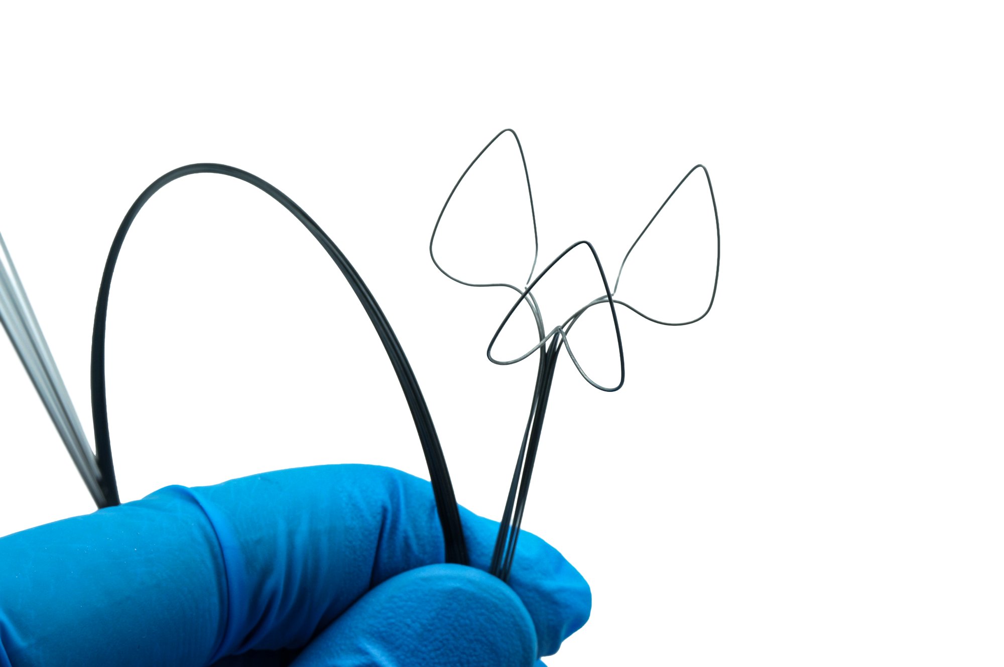 Shaped nitinol wire forms held in a gloved hand