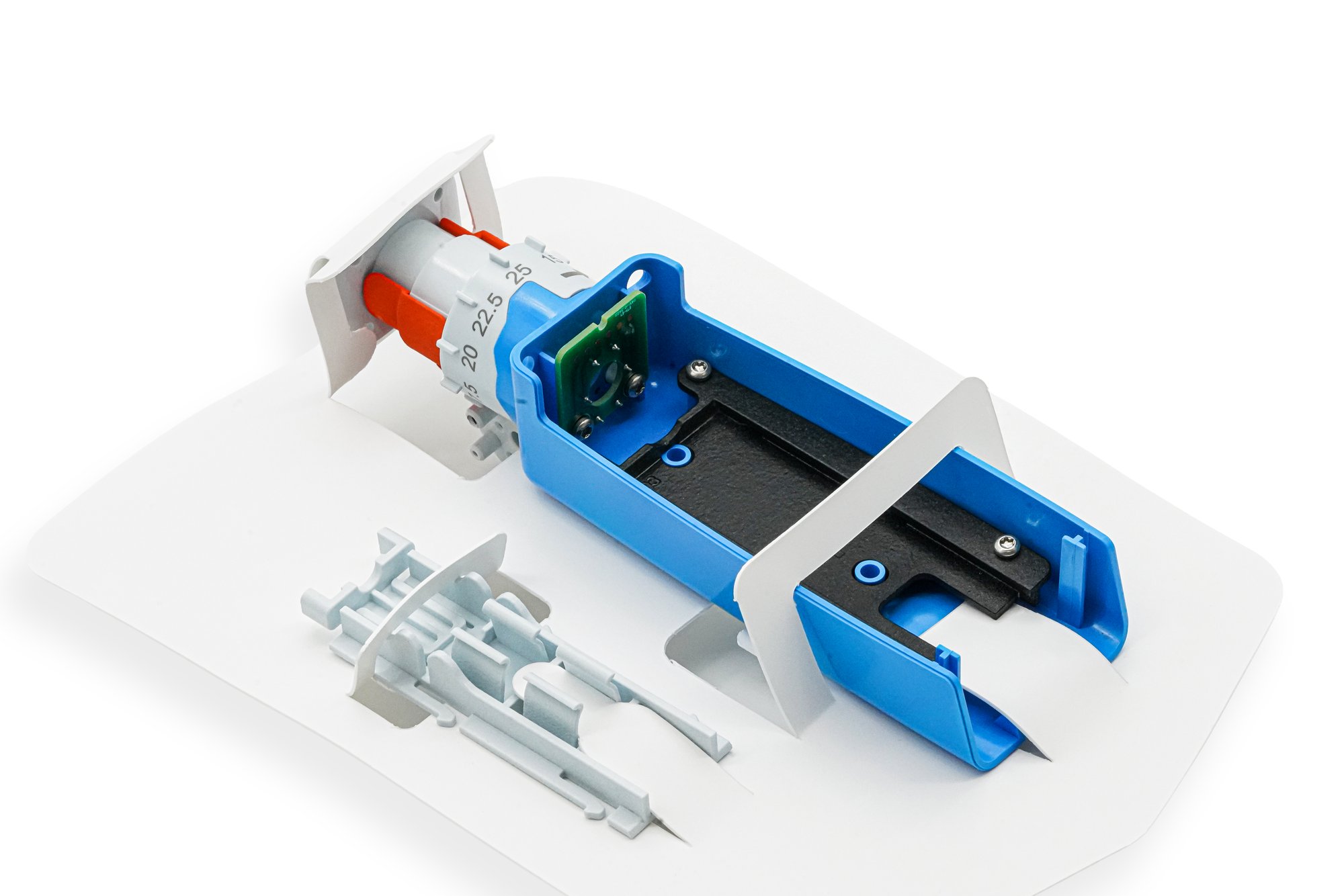 Curved laser-cut hypotube held in a gloved hand