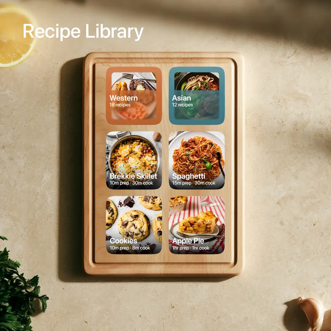 Recipe library with category and recipe tiles laid out on a wooden cutting board beside lemon, herbs and garlic