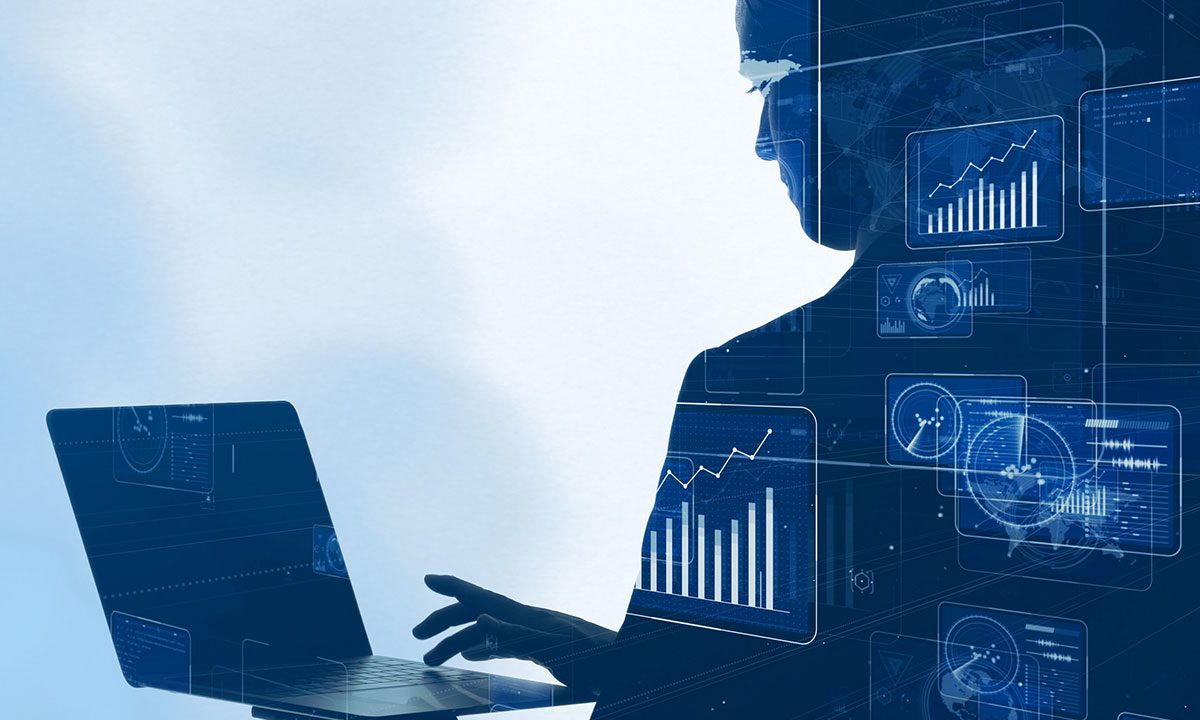 Silhouette of a person using a laptop with overlaid digital charts and graphs showing data analysis and growth trends.