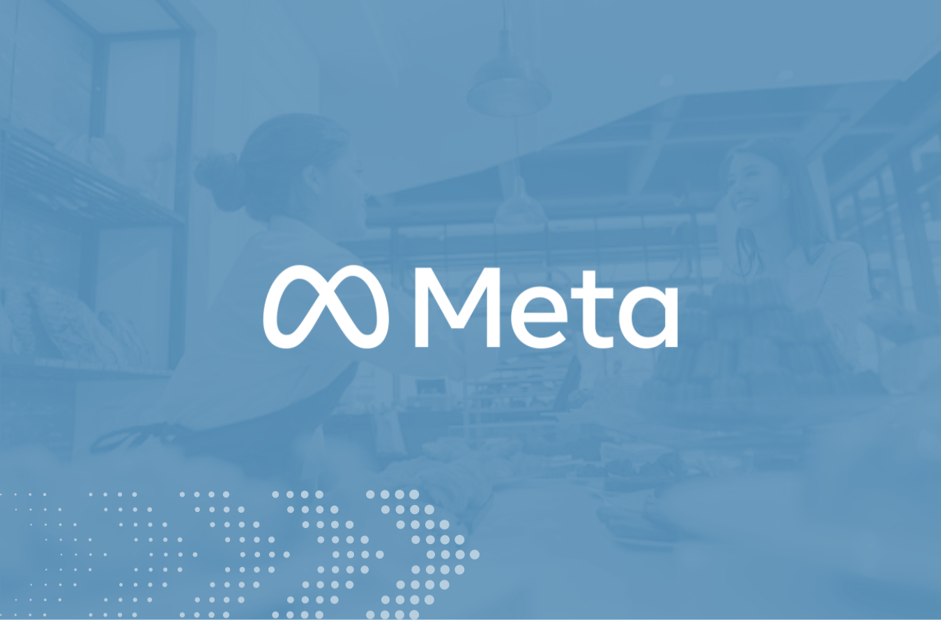 Meta logo over a blurred background showing two women interacting in a bakery.