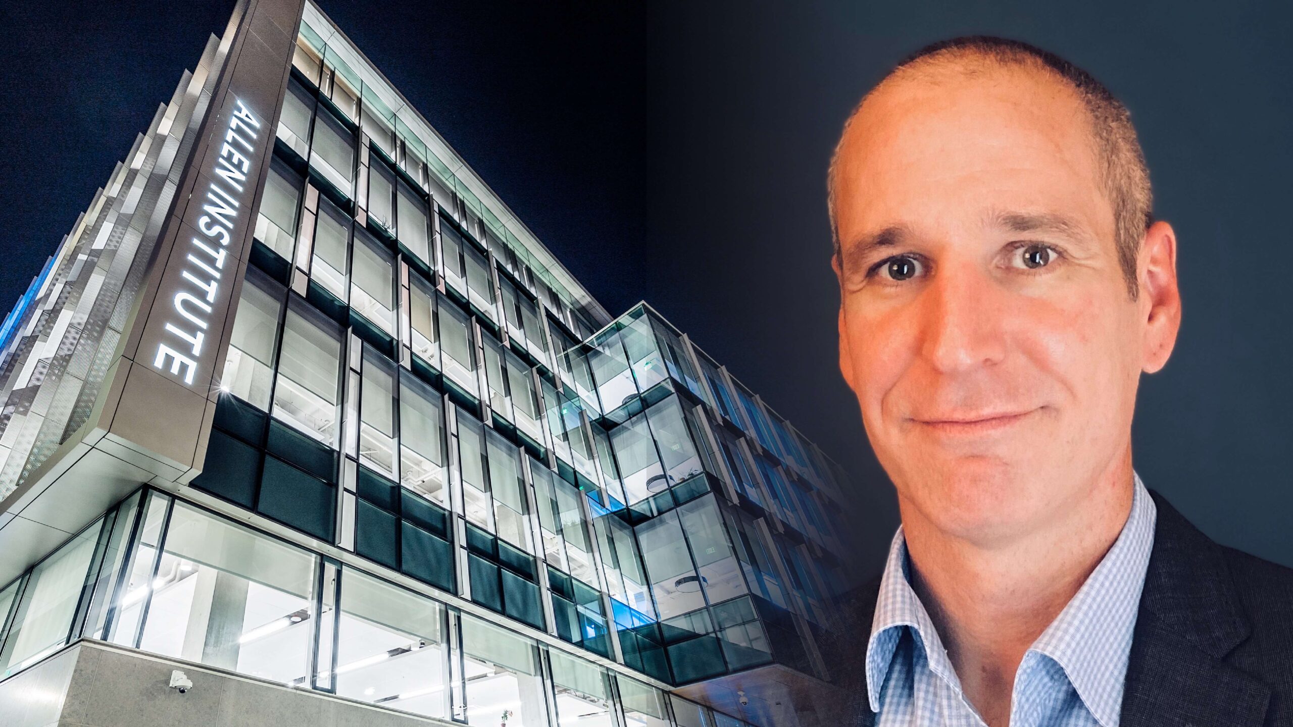 Man in business attire with illuminated office building at night