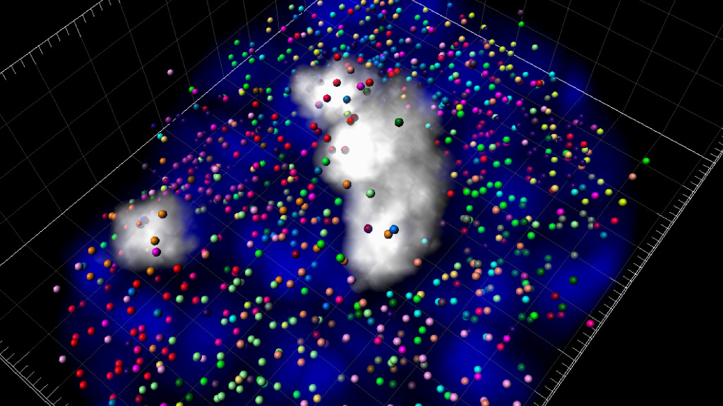 In a study published in the journal Cell, Caltech biologist Dr. Long Cai and his colleagues demonstrated a scaled up version of their technique, seqFISH, that let them view close to real-time activity of 10,000 genes in a single cell at once. In this 3D reconstruction of a mouse cell, chromosomes are stained blue and all the active genes in the cell are labeled with different colored dots that correspond to their native chromosome.