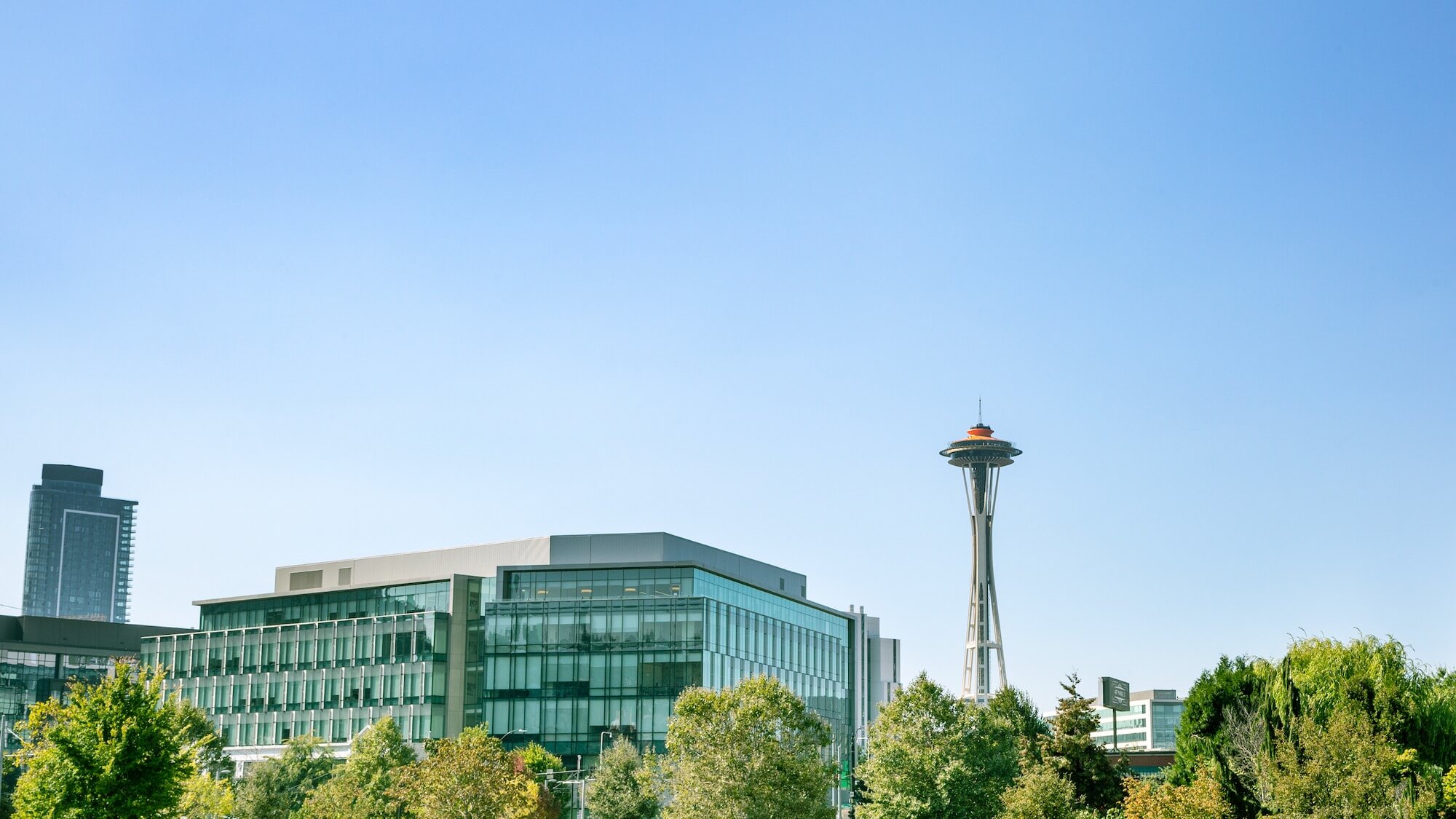 Seattle skyline with Space Needle tower and modern glass buildings under clear blue sky