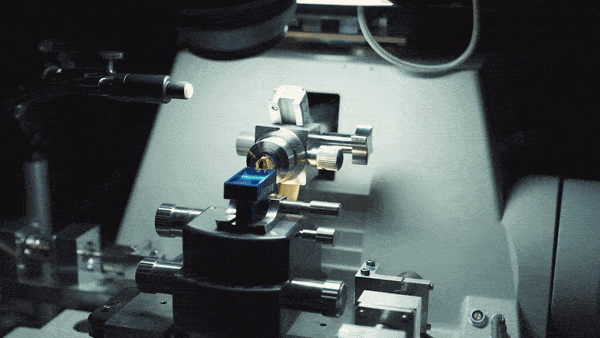 Precision lathe machine with metallic components under focused work light