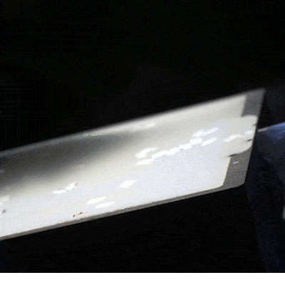 Fluorescent light fixture illuminated against black background