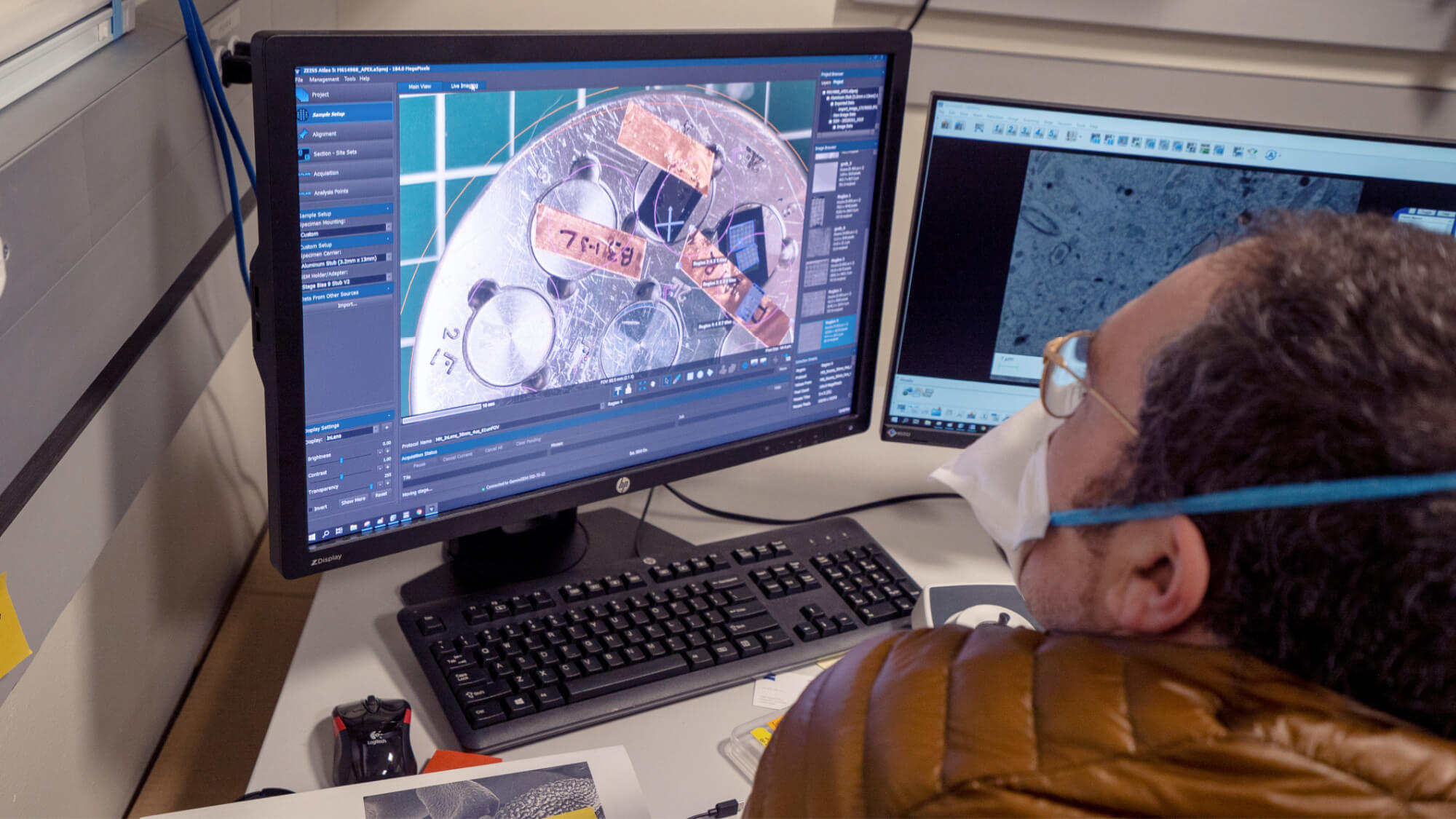 Person viewing aerial map software showing property layout on desktop computer monitor