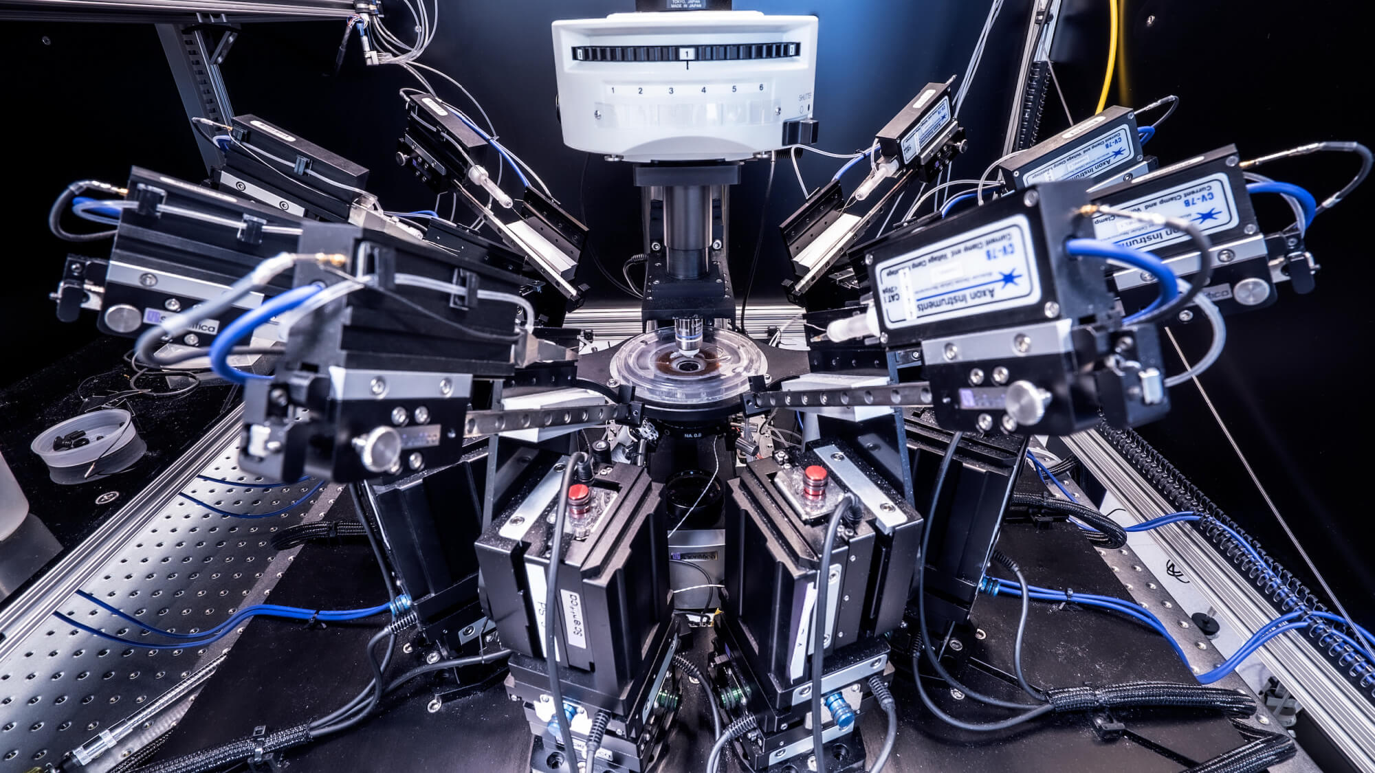 Advanced optical research equipment with multiple laser apparatus and measurement instruments on laboratory bench