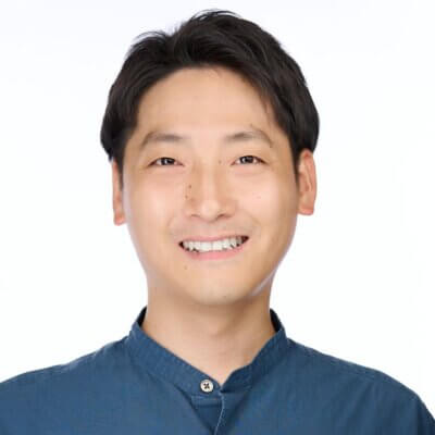 Smiling Asian man with black hair wearing dark blue button-up shirt