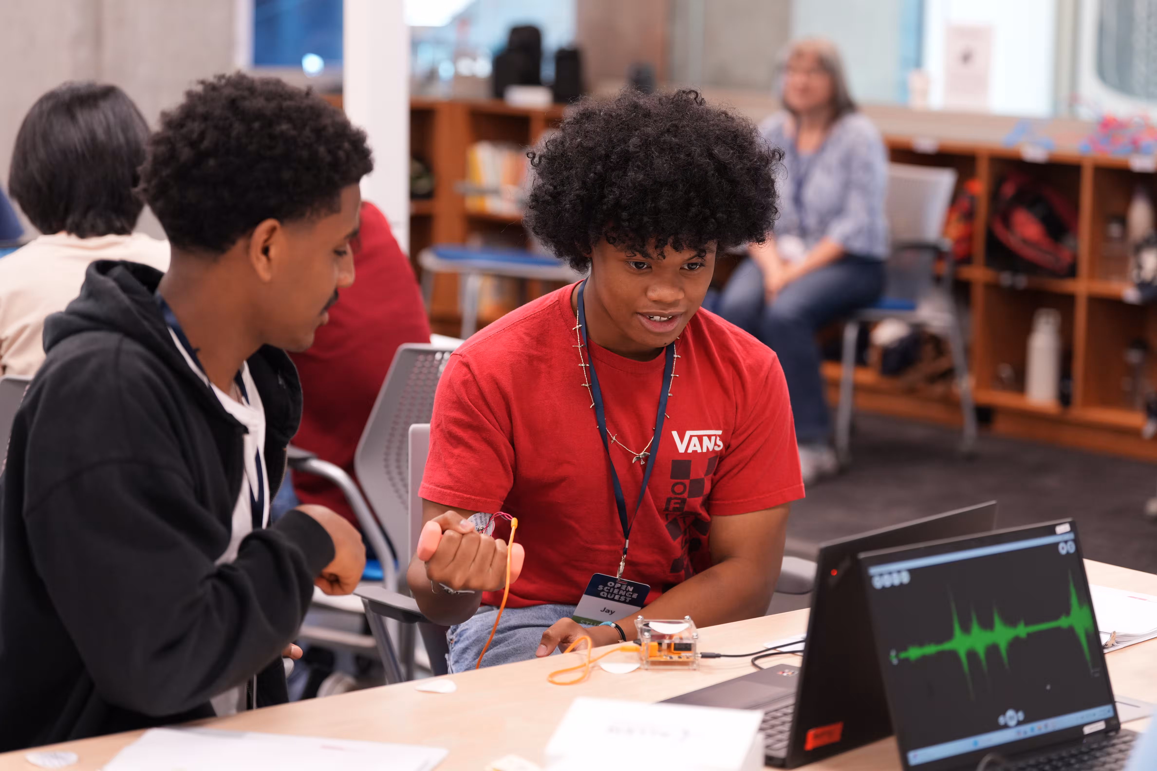 Students engage with electronics and wiring project at classroom workstation