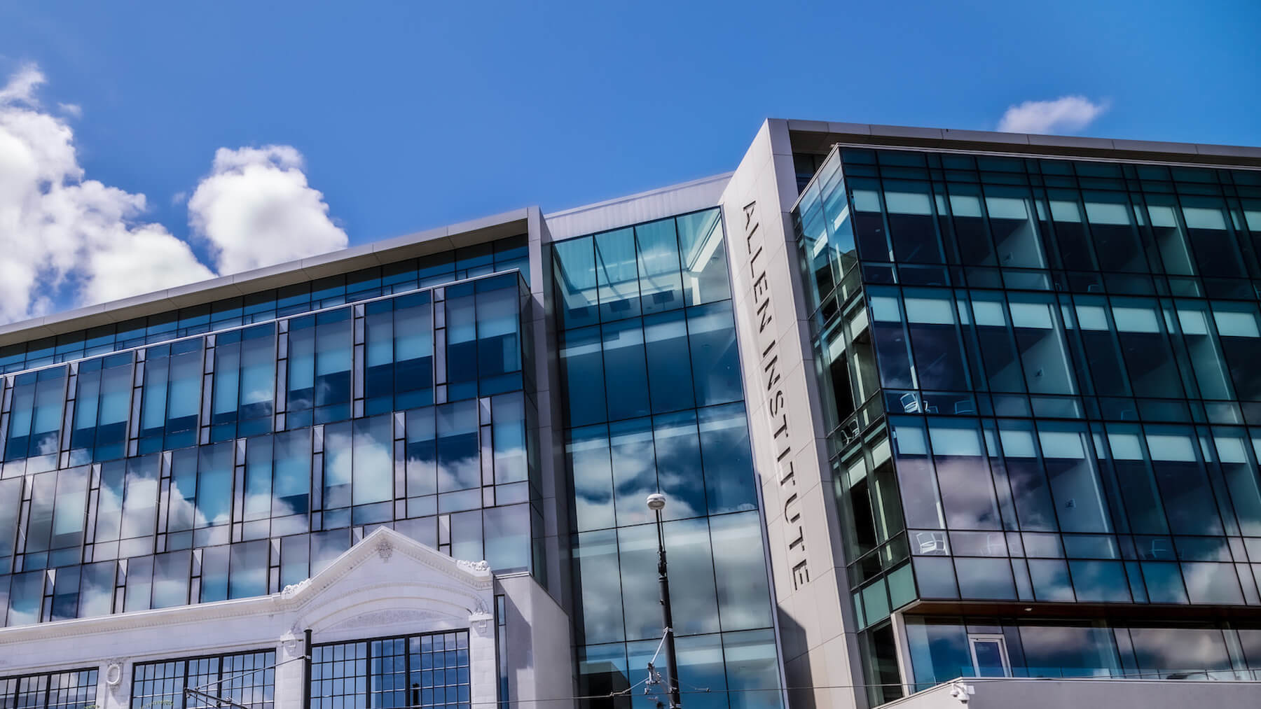 Modern glass office building with sky reflections on a clear blue day