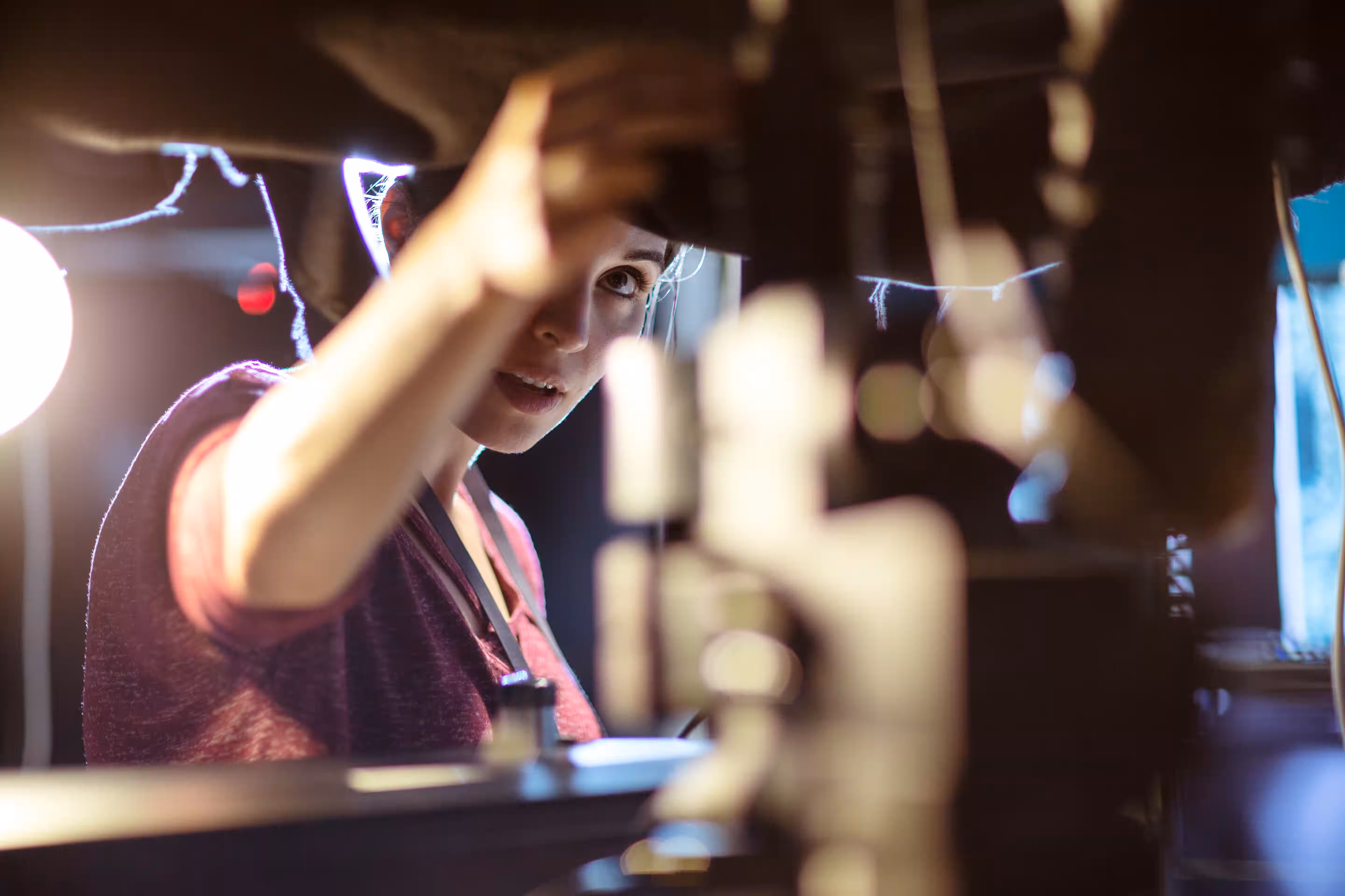Excited person at night with decorative lights in blurred urban setting