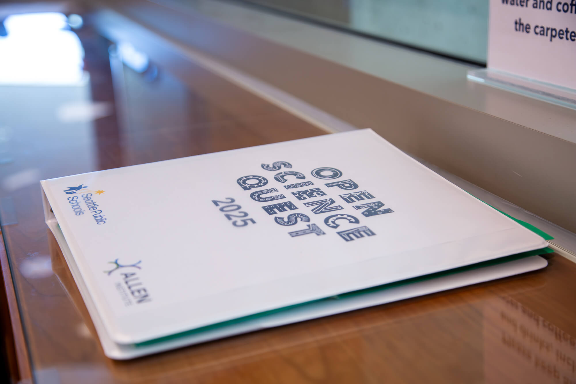 White brochure titled "Sustainability in Perspective 2025" displayed on wooden desk