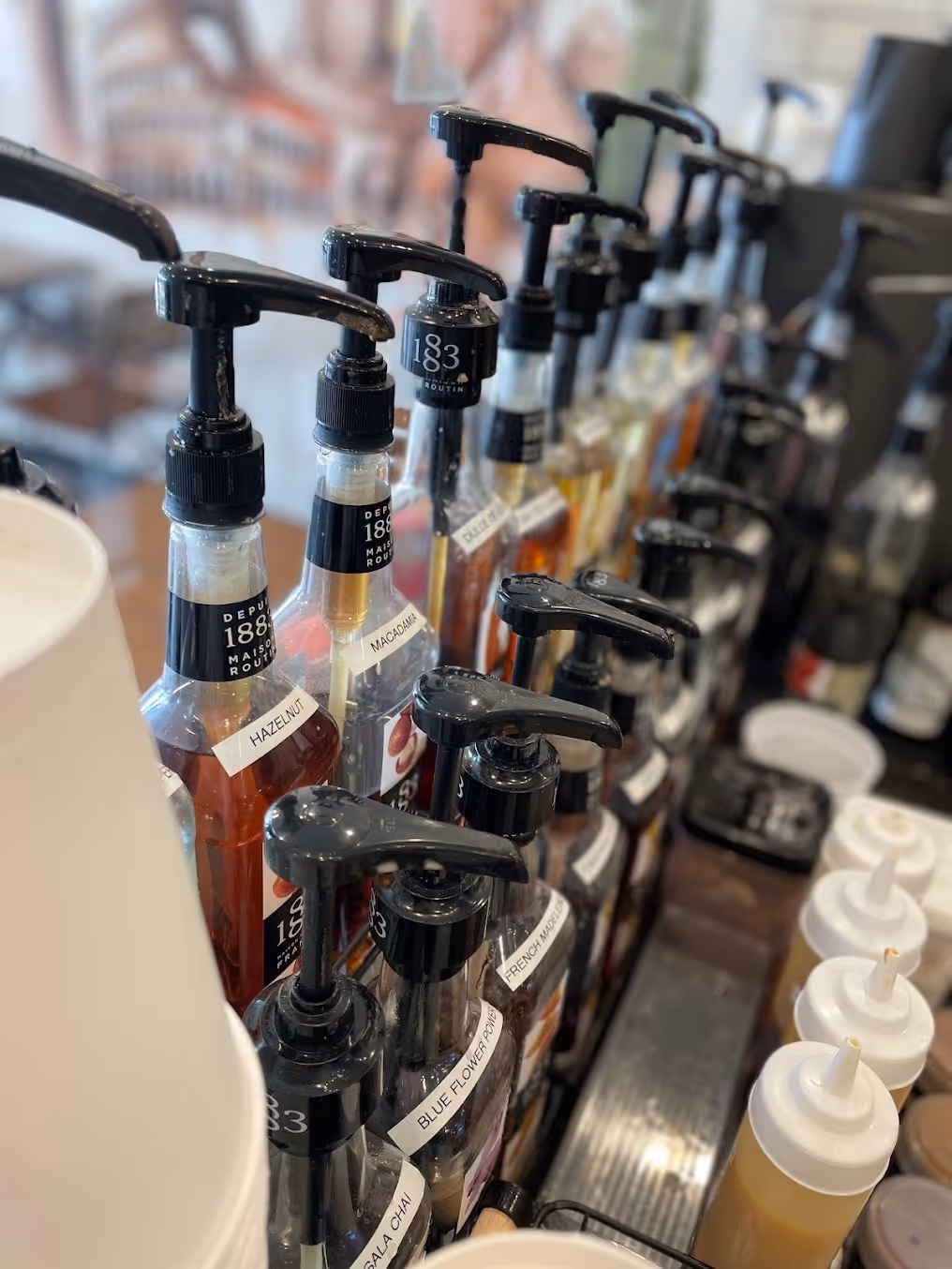 A bar displaying numerous bottles of assorted beverages, showcasing a diverse selection of drinks.