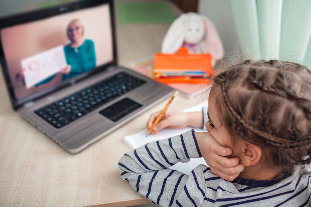Child participating in a reading intervention program, experiencing effective learning strategies through a virtual classroom session.