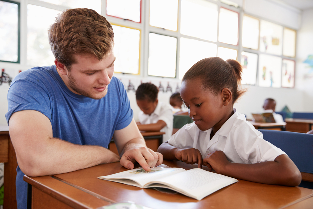 man helping kid with reading