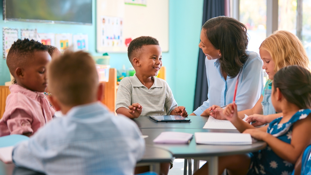 Kids enjoying a reading adventure with teacher in a vibrant classroom