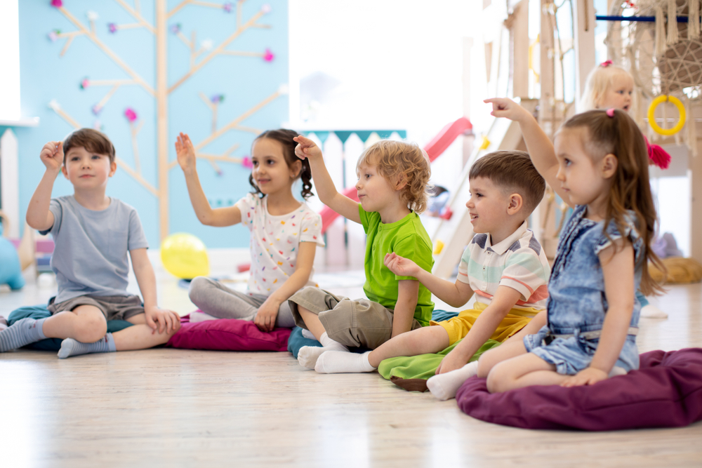 Energetic children participating in a group activity in a classroom, representing best practices for inclusive learning