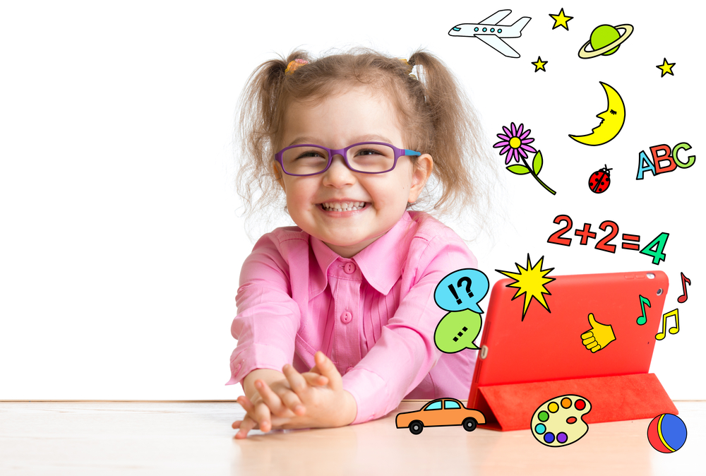 A smiling child enjoys learning with a tablet, representing the effectiveness of rewards programs for reading