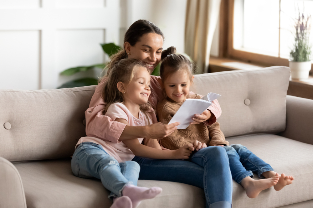 Mother reading with daughters for comprehension