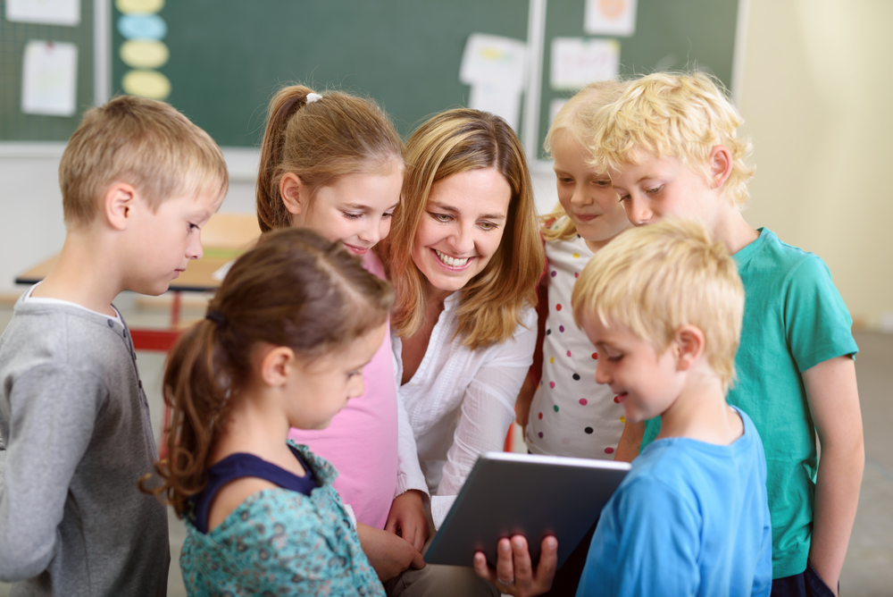 cheerful female teacher and her young students