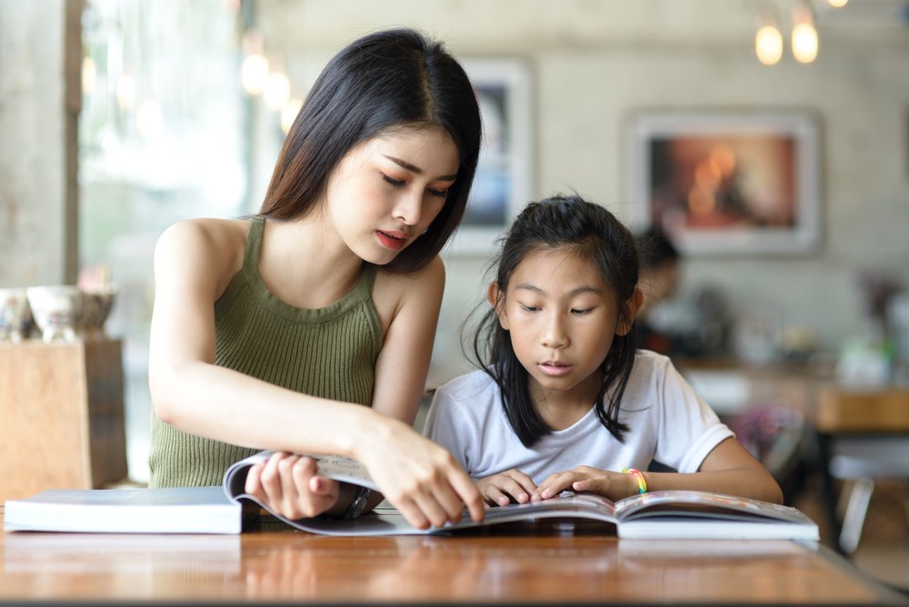 Private tutor working with child