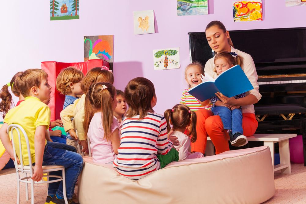 Teacher and children engaging in cognitive development learning activities in a classroom