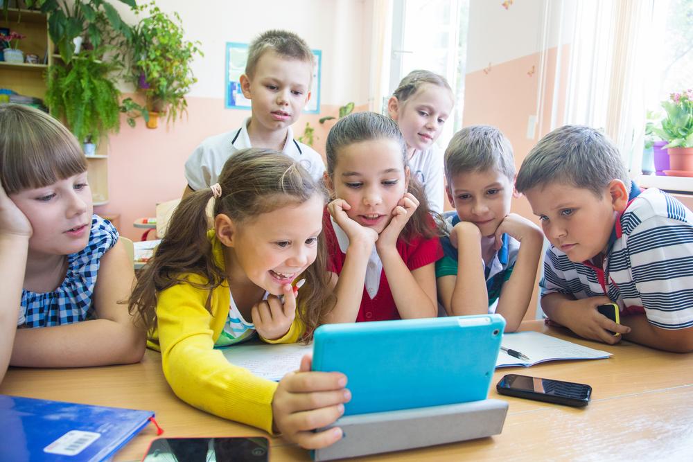 Children using a tablet for reading and comprehension