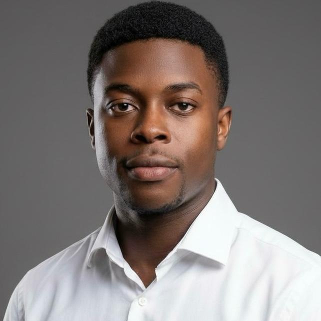 Portrait of a young Black man wearing a white button-up shirt against a gray background.