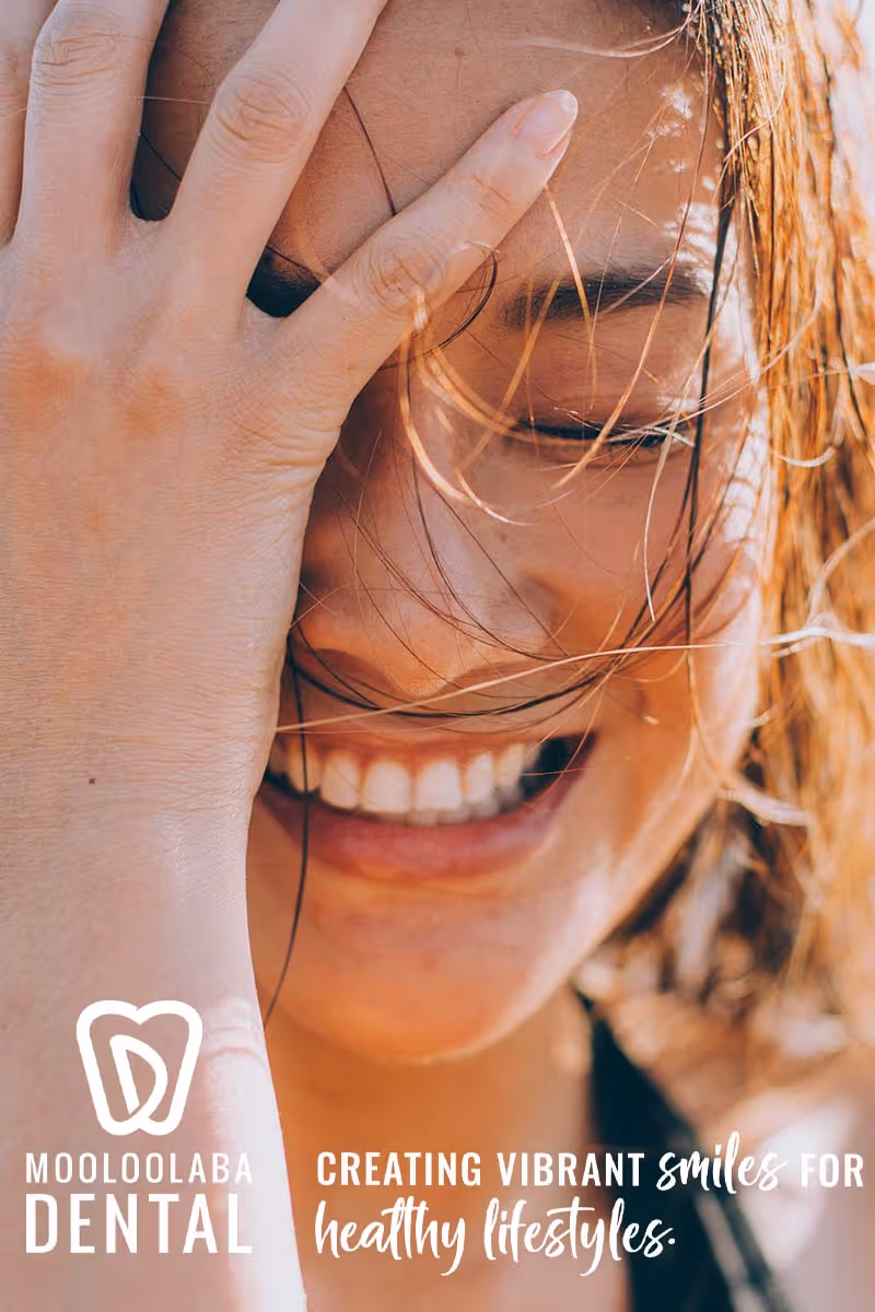 mooloolaba dental logo and tagline over image of woman
