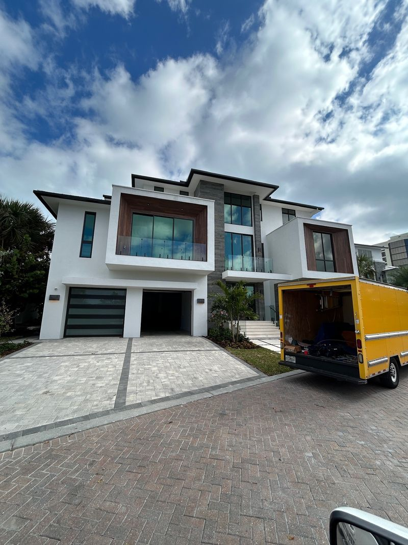 Front view of brick and stone home with landscaped yard and new shingle roof in Southlake TX