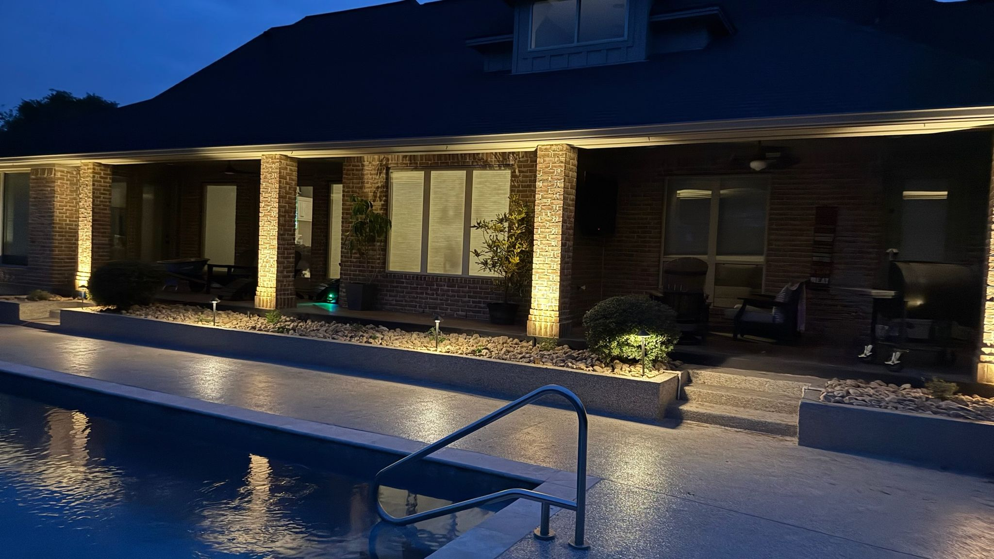 Aerial view of large stone home with new dark shingle roof in Southlake TX